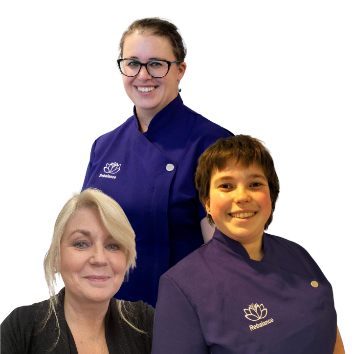 Three women in purple shirts posing for a photo.